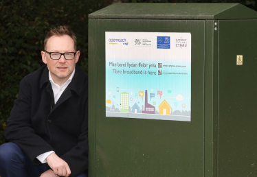 Russell stood with a broadband exchange box.